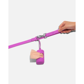 Dapper purple poop bag carrier dispenser on a leash with a partially pulled-out bag