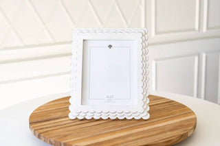 White wood scalloped photo frame for 8x10 photos on a round wood base.