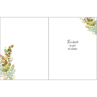 Retirement greeting card with watercolor leaves; green-brown foliage accents on corners and blue script The best is yet to come on the right panel.