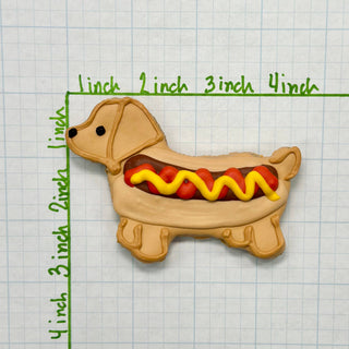 Lunch Menu Dapper dog biscuit shaped dachshund with beige fur, brown sausage and yellow mustard.