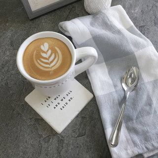 Coaster, white ceramic with printed message I asked if I was crazy and we all said no beside a latte mug