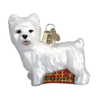 Westie ornament: white West Highland Terrier figure with red plaid base and gold hanging tag.