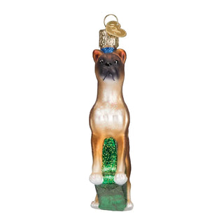 Boxer ornament, brown fawn with black muzzle, glitter accents, atop a green glitter base.