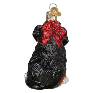 Bernedoodle puppy ornament, black glass with red glitter bow.