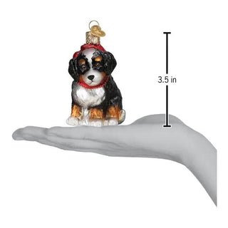 Bernedoodle puppy ornament, glass Christmas figurine with black, white and tan coat and red scarf, 3.5 in tall.