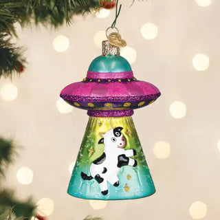Cow Abduction Ornament, glittery pink and teal UFO with a cow motif.