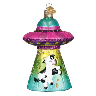 Cow Abduction Ornament, teal and pink glitter UFO-shaped holiday ornament with a jumping cow design