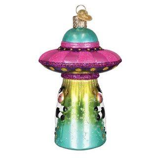 Cow Abduction Ornament: glass holiday ornament with a pink UFO saucer and teal-green beam, cow silhouettes.