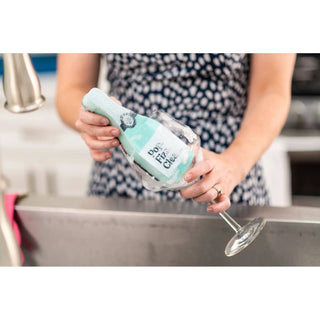 Scrubbly™ kitchen sponge in teal with foam cleaning a wine glass