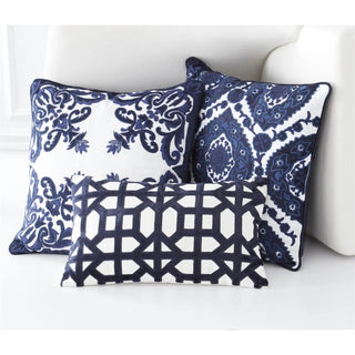 Three decorative pillows with royal blue velvet embroidery on white linen, featuring floral and geometric patterns.