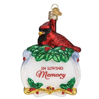 Memorial Cardinal Ornament: red cardinal perched on green holly leaves atop a white base with In Loving Memory inscription