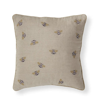 Beige linen pillow with scattered gold-bee embroidery and braided edge trim