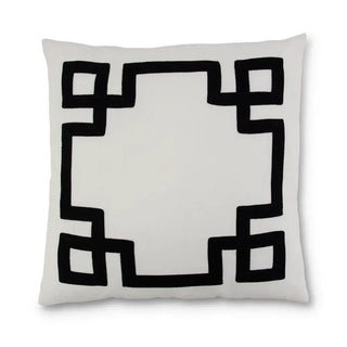 White linen pillow with black geometric border pattern.