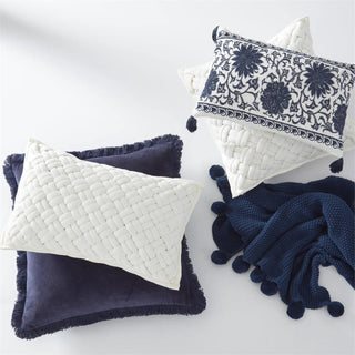 Rectangular blue and white embroidered mandala pillow with tassels; part of a three-cushion decorative set.