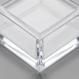 Clear acrylic cocktail napkin holder; square with beveled edges for stylish bar or table display.