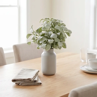 Lambs Ear Stem 20 in artificial flora in a gray ceramic vase on a wooden dining table.