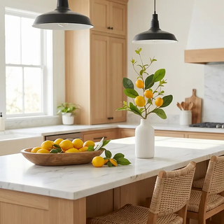 Lemon and foliage stem, 28-inch artificial flora with yellow lemons and green leaves in a white vase on a kitchen island