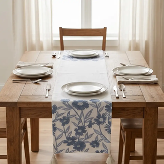 Table runner, 72-inch white linen with blue embroidered floral pattern and tassels.