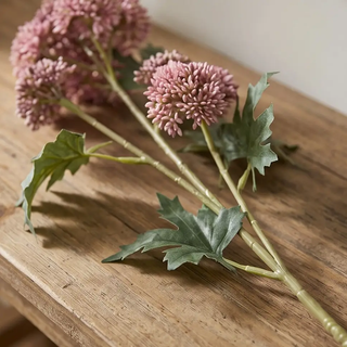 Pink sedum stem artificial plant with clustered pink blooms and green lobed leaves.