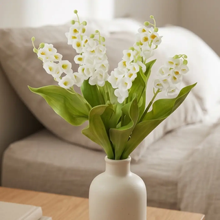 White Real Touch Lily of the Valley bundle, artificial flowering plants with green leaves in a cream vase.