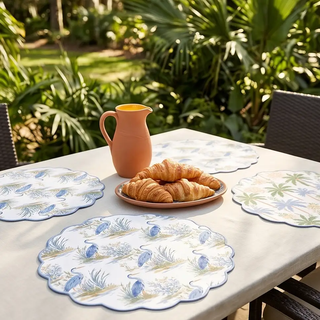 Placemats set of 4, reversible, featuring blue heron and palm motifs on white with scalloped edges