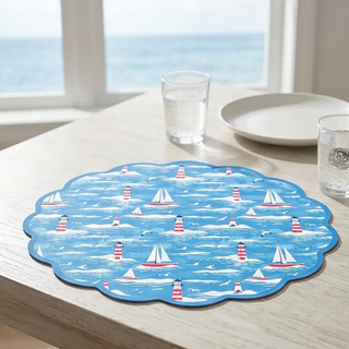 Placemat set of 4, scalloped blue nautical design featuring sailboats and lighthouses, reversible