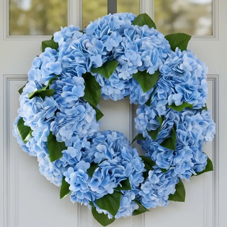 Blue Real Touch Hydrangea Wreath with green leaves on a front door