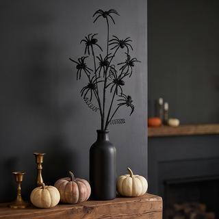 Black Glitter Spider Spray in a matte black vase, Halloween seasonal decoration on a wooden mantel.