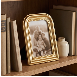 Arched 5x7 gold picture frame with ornate beaded inner edge.