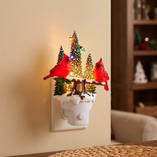 Animated Swirling Glitter Cardinal Night Light featuring snow-covered trees and two red cardinals on a plug-in base.