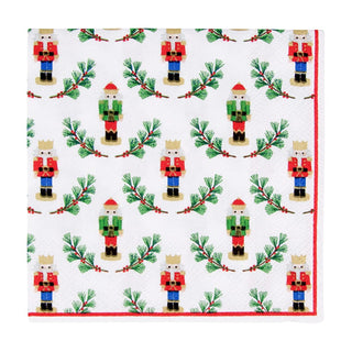 Cocktail napkin featuring Little Nutcracker motif on white with a red border and green pine sprigs.