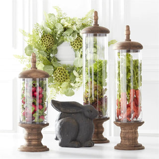 Eucalyptus Fern & Lotus Pod Wreath with greenery, displayed beside three glass terrariums