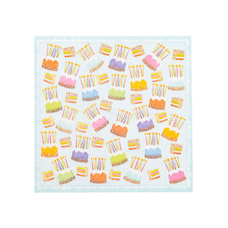 Cocktail napkins with pastel cake and candle patterns on pale blue paper linen background