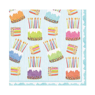 Luncheon napkin, cake-frosting design with candle-topped cakes, paper linen on blue striped background