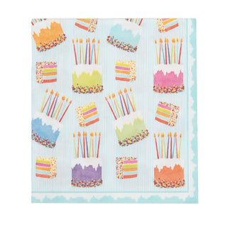 Luncheon napkin with cake-frosting pattern on light blue striped background, featuring colorful cakes and candles.