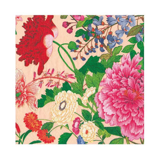 Luncheon napkin with vibrant floral pattern of pink, red, blue and white blossoms on a peach background