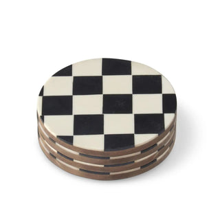 Wood coasters, five round black-and-white checkered enameled, stacked.