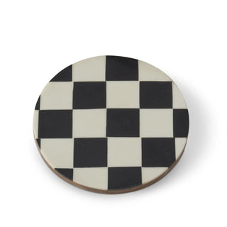 Round wooden coasters with a black and white checkerboard enamel finish.