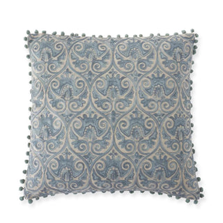 Square blue-gray crest-embroidered pillow in damask pattern with teal pom-pom trim