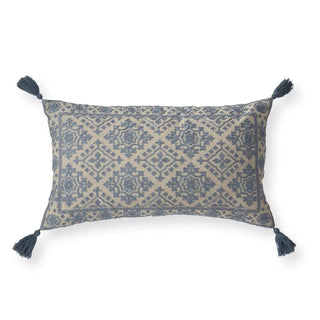 Handcrafted beige and blue embroidered lumbar pillow with tassels.