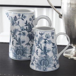 Two navy blue and white porcelain chinoiserie pitchers with floral motif.