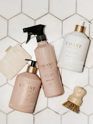 Three L'AVANT dish soaps in Blushed Bergamot: pink spray bottle, pink pump bottle, and white pump bottle.