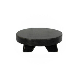 Riser, round black wooden, 6x6x2 inches, with tripod-style legs.
