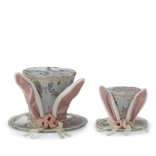 Two blue floral bunny-ear top hats with pink ears, lace trim and ribbon roses.