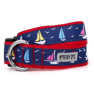 Sailboats dog collar in blue fabric with red trim, sailboat print, and silver metal D-ring.