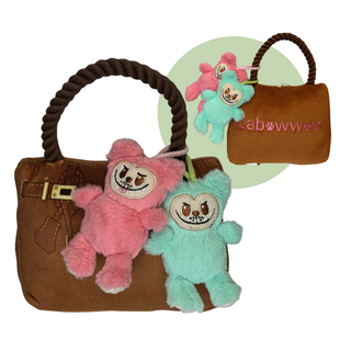 Labowwow handbag with two plush monkeys in pink and turquoise on a brown faux suede bag with a braided rope handle.
