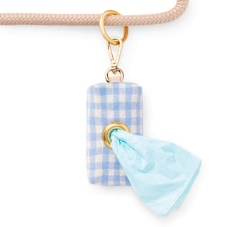 Waste bag holder in sky blue gingham fabric with gold-tone hardware and a light blue bag.