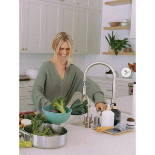 Fresh Linen High Performing Dish Soap white pump bottle on a kitchen counter beside brushes
