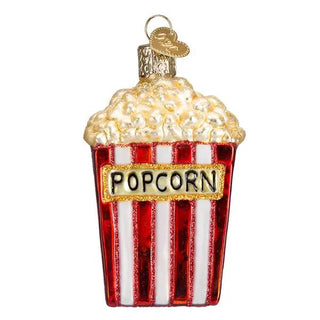 Popcorn ornament in red and white striped bucket with gold POPCORN label, fluffy popcorn top, hanging loop.