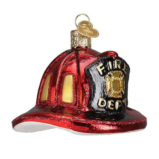 Fireman's helmet ornament, red glass with black shield reading FIRE DEPT and gold emblem.